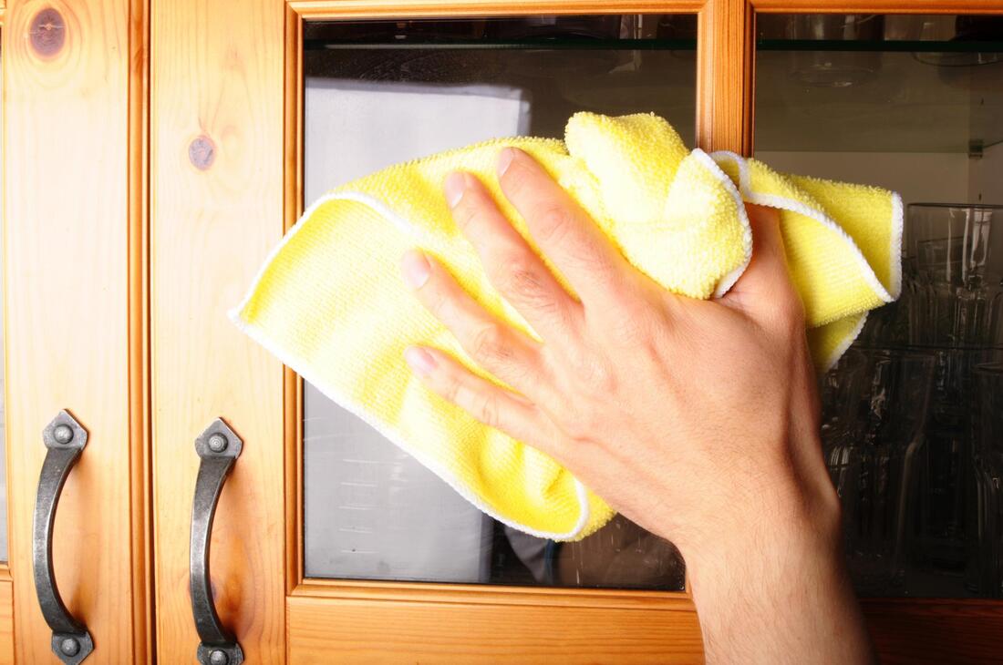 woman cleaning a cabinet