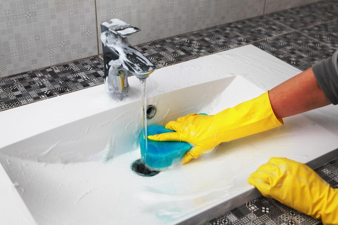woman cleaning a sink