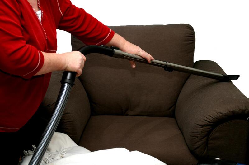 woman cleaning a sofa